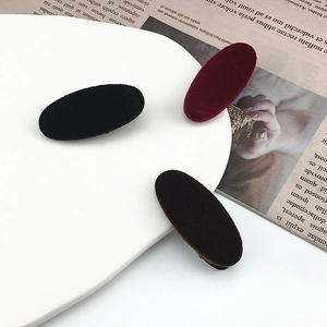 Elegant set of 3 oval velvet hair clips in black and burgundy on a stylish tray