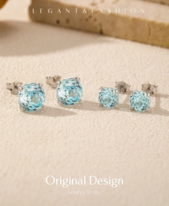 Close-up of s925 silver stud earrings with round rose cut light blue crystal gemstones