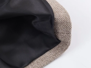 Detail of herringbone wool fabric seam and smooth striped satin lining on the blazer