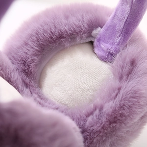Close-up of soft purple faux fur ear muffs showing plush texture and fleece lining