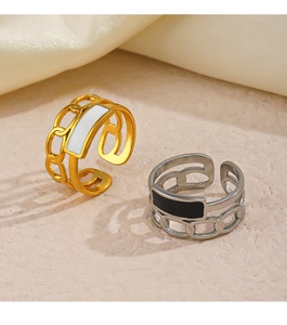Close-up of adjustable chain rings with gold and silver finishes and enamel inlay