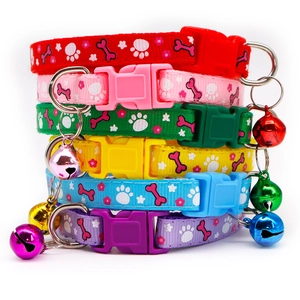Detail view of colorful polyester pet collars with various patterns and metal bells
