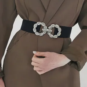 Women's wide elastic waist belt featuring a decorative silver twisted double-ring buckle