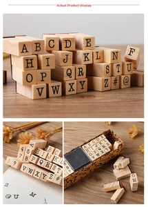 Close-up of 40-piece wooden typewriter alphabet and number stamps in a vintage box