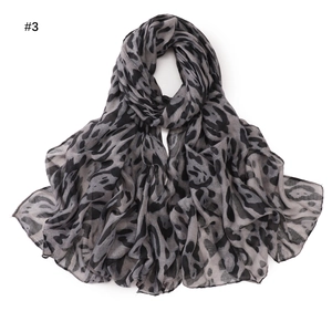 Detail shot of lightweight grey leopard print scarf with smooth chiffon texture and drape