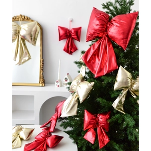 Glossy red and gold Christmas bows for holiday tree decoration and festive wall hanging