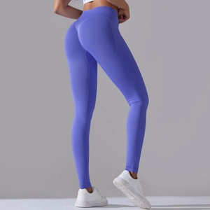 Detailed view of seamless purple yoga pants featuring a cross-waist and peach lift design