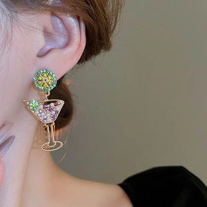 Close-up of lime cocktail glass earrings with pearls and colorful rhinestones on model