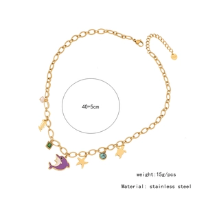 Detail of gold ocean charms necklace showing starfish and turtle on stainless steel chain