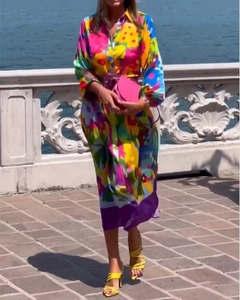 Detail of vibrant floral print shirt dress with long sleeves and colorful patterns