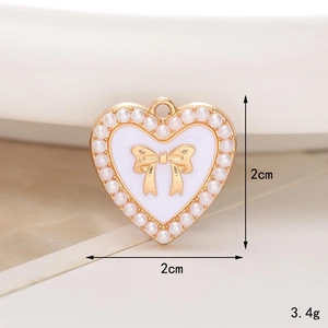 Macro view of heart charm with gold bow and pearls for clog shoe decoration, 2cm size
