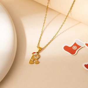 Detail of golden Gingerbread Man and letter R necklace with red Christmas hat
