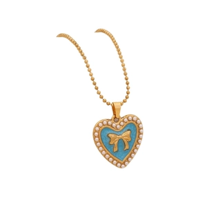 Golden heart necklace with blue enamel center, gold bow and pearl trim on bead chain