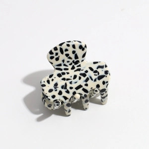 Detail of a spotted marble patterns on a polished cream acetate hair claw clip