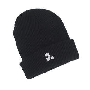 Close-up of black ribbed knit beanie featuring a white embroidered J. letter logo