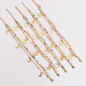 Multicolor beaded gold bracelets with moon, heart, and swan pendants in a stackable style
