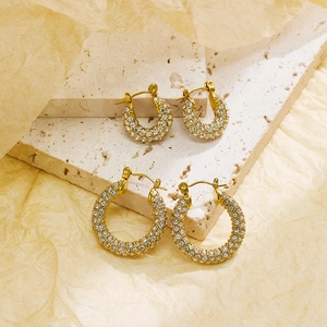 Detail of gold-plated hoop earrings with crystal pavé in two different sizes