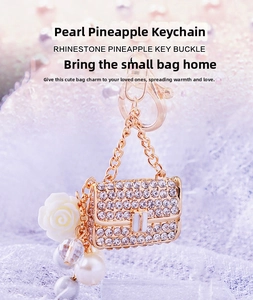 Macro view of crystal rhinestone handbag keychain with white rose and pearl charm