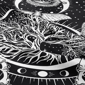 Close-up of bohemian tapestry showing intricate tree of life and mystical moon phase prints