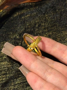 Macro detail of vintage gold ring with star and sun engravings and cubic zirconia