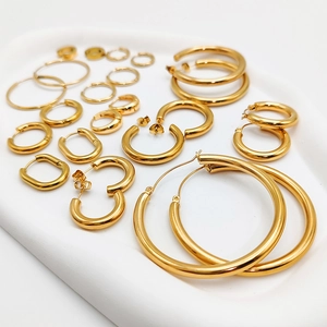 Close-up of assorted gold-plated stainless steel hoop earrings in various shapes and sizes