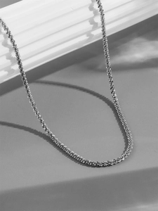 Detail view of a silver popcorn chain necklace featuring textured minimalist metal links