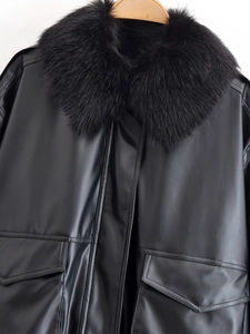 Detail of black leather jacket featuring a luxury faux fur collar and large flap pockets