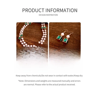 Detailed view of vintage emerald crystal and pearl necklace and earring jewelry set