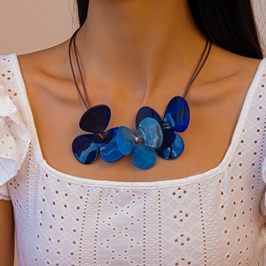 Blue acrylic clover flower layered wax cord necklace worn on model for fashion look