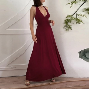 Detail of burgundy backless halter dress with a deep V-neck and flowing maxi skirt