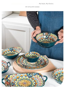 Detail view of Bohemian ceramic bowl featuring mandala patterns and side handles