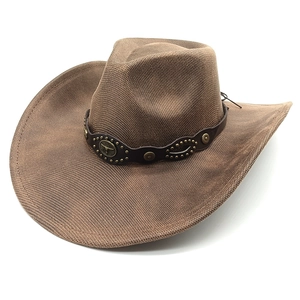 Detail of western brown woven cowboy hat featuring embossed bull head metal ornament