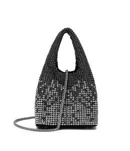 Detailed view of silver rhinestone evening bucket bag with chain strap and metal feet