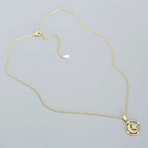 Close-up of gold s925 silver moon and star necklace with shimmering zircon stones