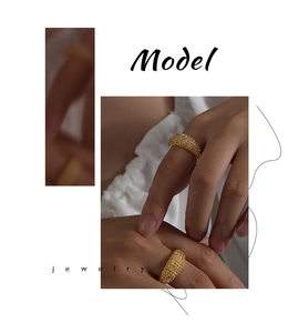 Close-up of model wearing two luxury gold titanium rings with paved Czech crystals