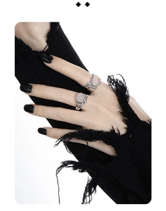 Detail of silver S925 rings with round pink agate stones worn on a model's hand