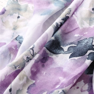 Macro view of Chinese style watercolor floral printed fabric with vibrant purple and blue hues