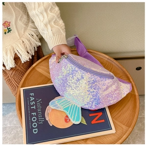Detail of purple sequin mermaid tail fanny pack for kids on a wooden table setup