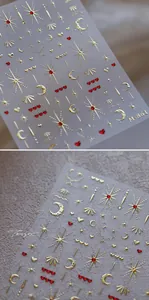 Macro detail of 3D embossed gold and red moon star nail stickers with metallic texture