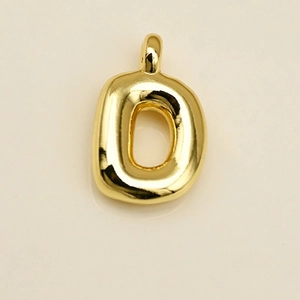 Detailed close-up of a polished gold letter D charm with a smooth 3D bubble design