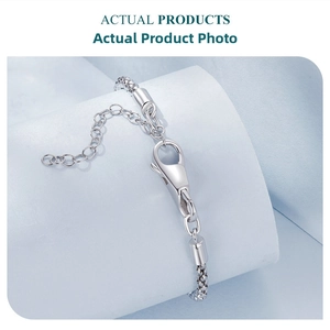 Macro shot of 925 sterling silver snake chain bracelet with secure lobster clasp and extender