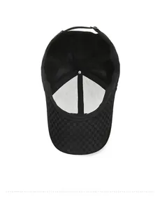 Detail view of the black baseball cap showing the interior checkered cotton lining and seams