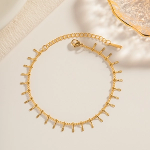 Detail view of 18K gold plated stainless steel chain with small textured bar pendants