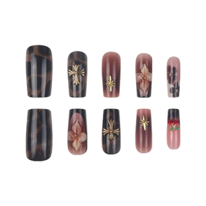 Retro brown press-on nails set with vintage flower patterns, crosses, and cherry gems