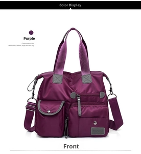 Front view of purple nylon travel bag with multiple pockets and adjustable shoulder strap