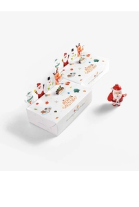 Detail of Christmas gift boxes with Santa and reindeer prints on white folding paper