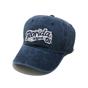 Detail of vintage denim baseball cap with Florida embroidery and washed blue texture
