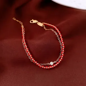 Double-layer 18k gold plated bracelet with red cord, gold beads and a sparkling zircon stone