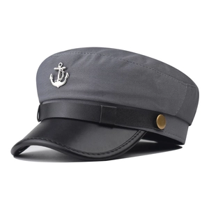 Detailed close-up of a dark grey military hat with silver anchor badge and leather brim