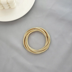 Minimalist gold multi-layer coiled ring with textured snake bone style finish
